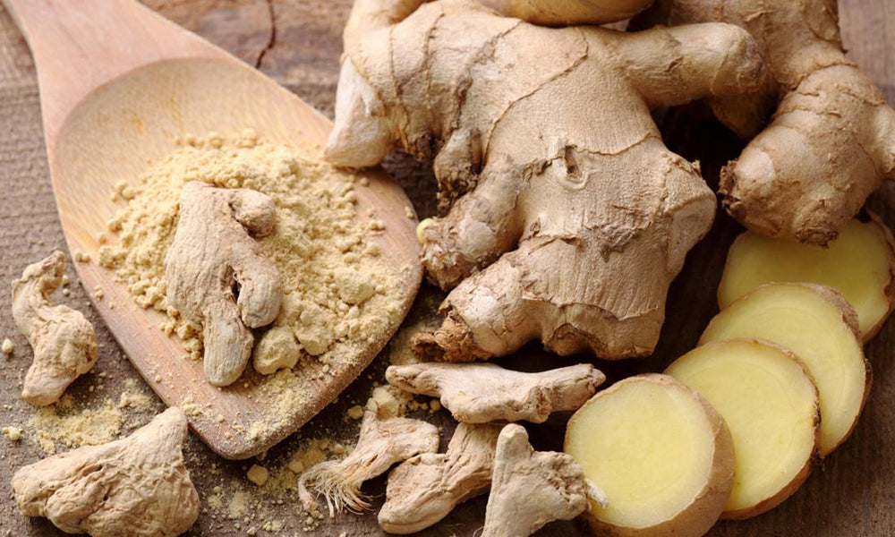 Fresh whole and sliced ginger on a table